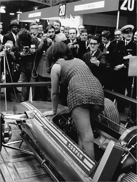 Female model climing in to Cooper F5000 at 1969 Racing Car show. Creator: Unknown