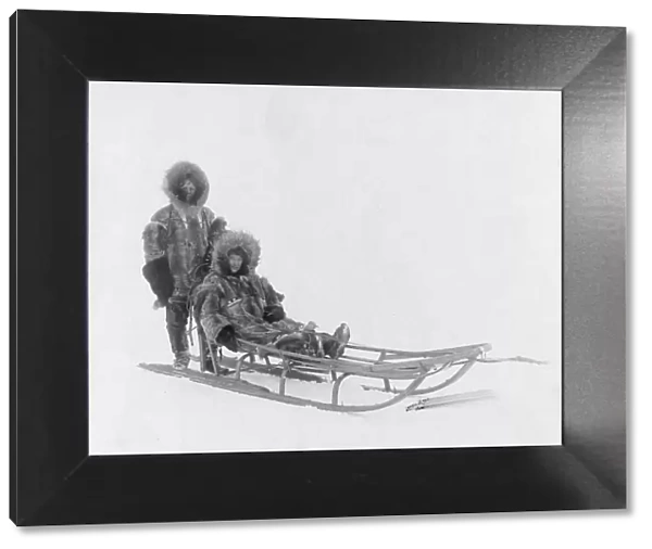 Couple on dog sled, between c1900 and 1927. Creator: Lomen Brothers