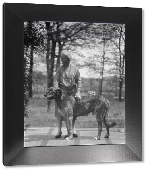 Noland, Charlotte, Miss, with dog, standing outdoors, 1931 May 8. Creator: Arnold Genthe