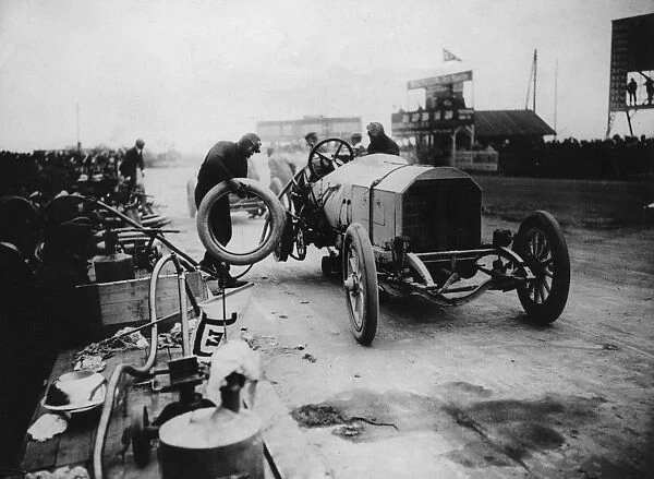 1908 Mercedes, Lautenschlager, changing wheel, winner French Grand Prix. Creator: Unknown