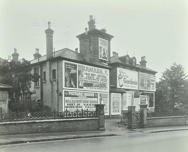 Advertising hoardings on the wall of a building, Wandsworth, London, 1938