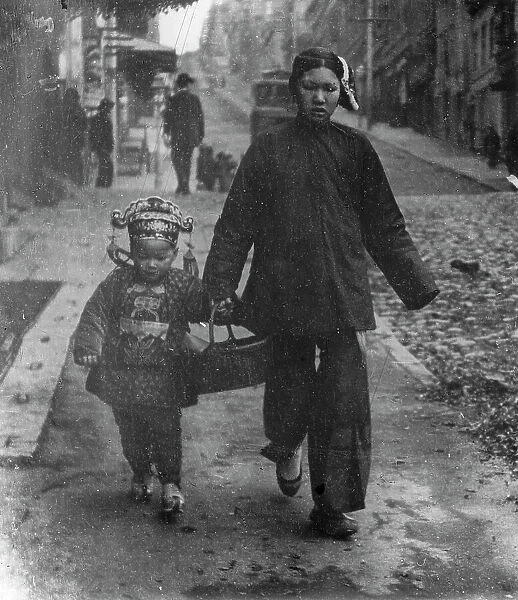 Carrying New Year's presents, Chinatown, San Francisco, between 1896 and 1906. Creator: Arnold Genthe