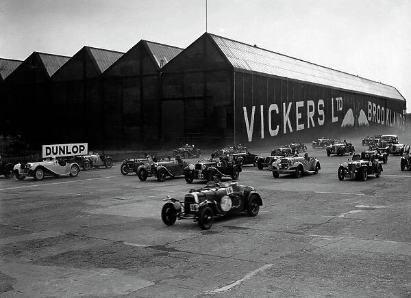 Cars racing at the MCC Members Meeting, Brooklands, 10 September 1938. Artist: Bill Brunell