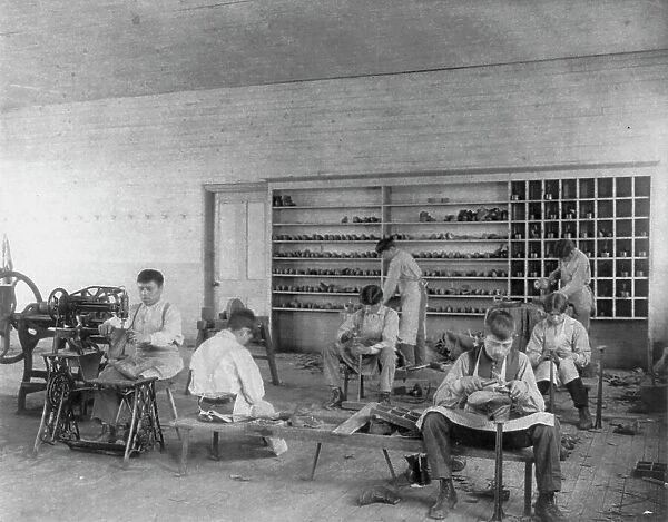 Classroom scenes at Carlisle, Pa. Indian School. Shoe making and repairing; male students, 1901. Creator: Frances Benjamin Johnston
