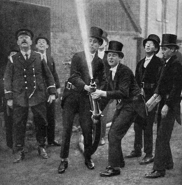 Etons amateur firemen practising a hose drill, Berkshire, c1922