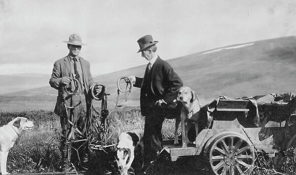 Frank G. Carpenter beside pupmobile, between c1900 and 1916. Creator: Unknown