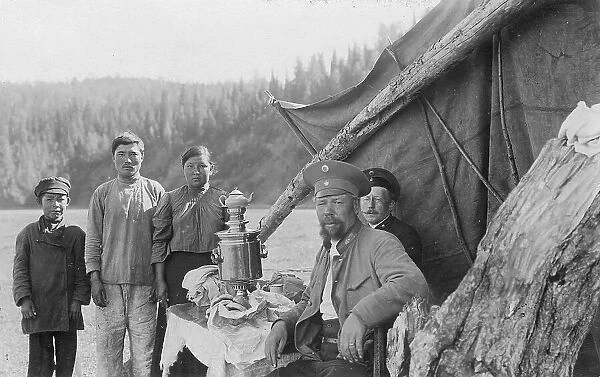 G.I. Ivanov and a Shoria Family at the Table with Samovar Near the Tent, 1913. Creator: GI Ivanov