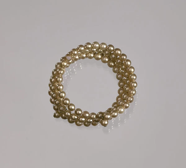 Gold pearl coil bracelet from Maes Millinery Shop, 1941-1994. Creator: Unknown