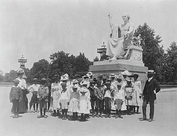 Group of school children in front of statue of George Washington, Washington, D.C. (1899?). Creator: Frances Benjamin Johnston