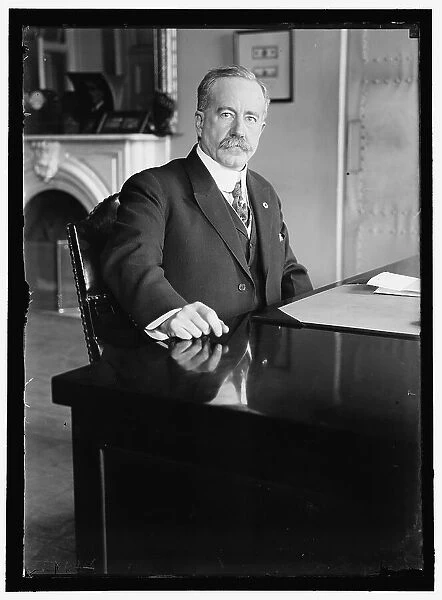 John Skelton Williams at desk, between 1913 and 1918. Creator: Harris & Ewing. John Skelton Williams at desk, between 1913 and 1918. Creator: Harris & Ewing