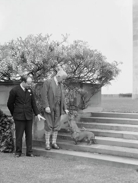 Kahn, Otto H. Mr. and unidentified man, with dog, standing outdoors, 1928 Creator: Arnold Genthe