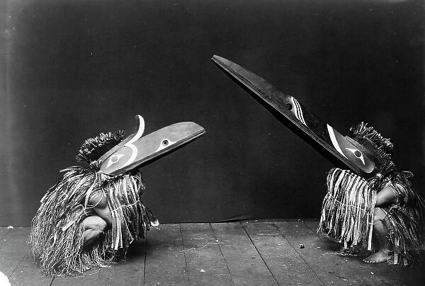 Kotsuis and Hohhug-Nakoaktok, wearing ceremonial dress, with long beaks, on their haunches... c1914 Creator: Edward Sheriff Curtis