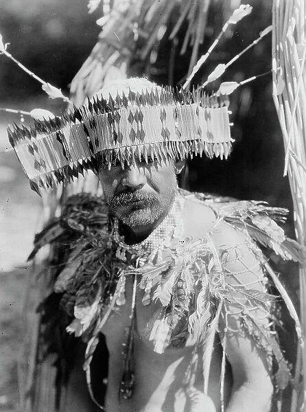Man in Pomo dance costume, half-length portrait, facing front, c1924. Creator: Edward Sheriff Curtis