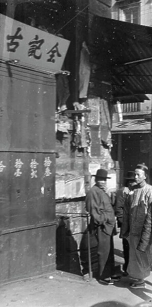 Two men standing on a sidewalk, Chinatown, San Francisco, between 1896 and 1906. Creator: Arnold Genthe