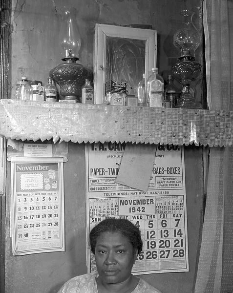 Negro woman in her home, Washington (southwest section), D. C. 1942. Creator: Gordon Parks