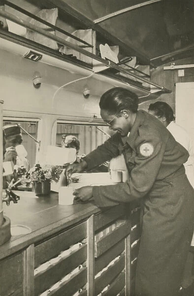 Picture postcard of a volunteer serving troops out of a Red Cross Clubmobile'