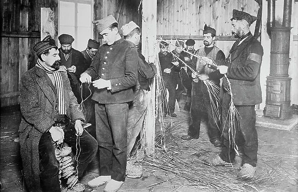 Prisoners at Zossen making straw shoes, 24 Feb 1915. Creator: Bain News Service