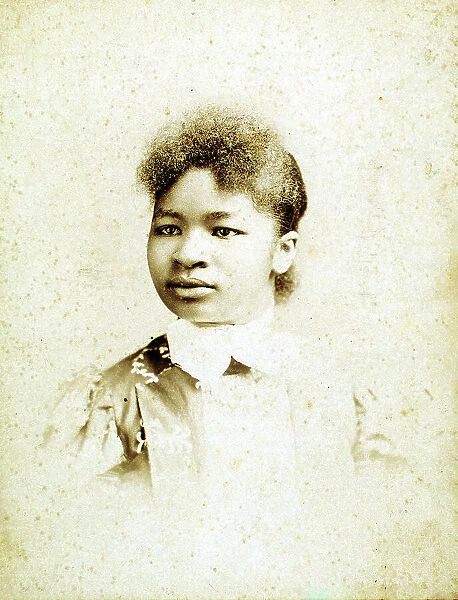 Studio portrait of young woman, head turned to her right, (1880-1900?). Creators: Stanton & Burdick, Unknown. Studio portrait of young woman, head turned to her right, (1880-1900?). Creators: Stanton & Burdick, Unknown
