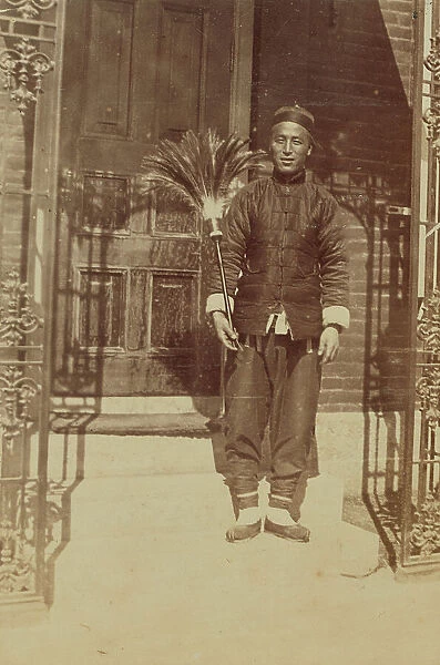 Thune Chin Sin, a Chinese house servant and errand boy, holding feather duster... 1899. Creator: Eleanor Lord Pray