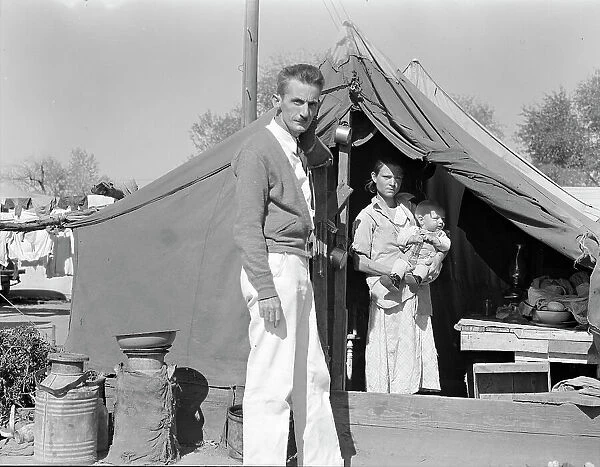 Tom Collins, manager of Kern migrant camp, California, with migrant mother and child, 1936. Creator: Dorothea Lange