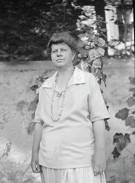 Unidentified woman, possibly Mrs. Cosgrave, standing outdoors, not before 1917. Creator: Arnold Genthe