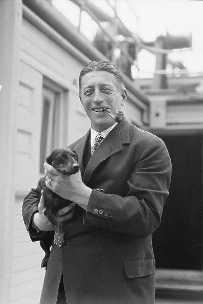 Von Lueckner, Felix, Count, with dog, standing outdoors, 1931 June 5. Creator: Arnold Genthe
