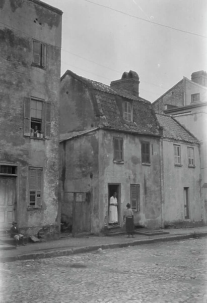 Woman and child standing in or by a doorway, [17 Chalmers Street], Charleston, South Ca. c1920-1926 Creator: Arnold Genthe