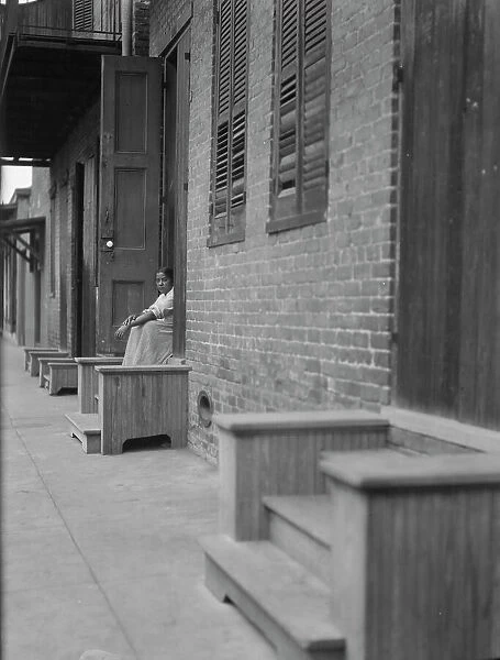 Woman sitting on steps, New Orleans or Charleston, South Carolina, between 1920 and 1926. Creator: Arnold Genthe