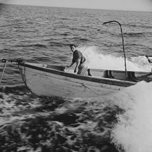 Giacomo Frusteri in the prow of the seining boat as it races to... Gloucester, Massachusetts, 1943. Creator: Gordon Parks