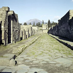 A Pompeii street with Vesuvius in the distance, Italy