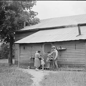 Tobacco sharecropper and his family at the back... Person County, North Carolina, 1939. Creator: Dorothea Lange