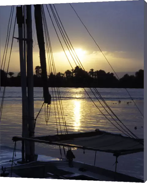 An anchored felucca on the River Nile at sunset