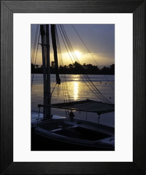 Framed Print : An anchored felucca on the River Nile at sunset Framed Print : An anchored felucca on the River Nile at sunset
