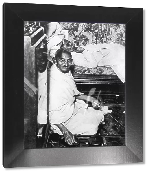 Mohondas Karamchand Gandhi (1869-1948), working at his spinning wheel