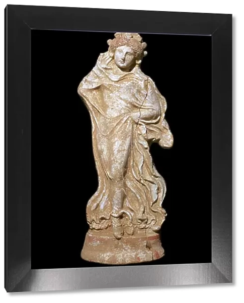 Greek terracotta of a woman in a flowing dress