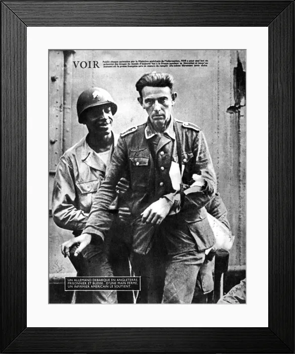 Framed Print : German prisoner of war arriving in England, escorted by an American soldier, 1944 Framed Print : German prisoner of war arriving in England, escorted by an American soldier, 1944