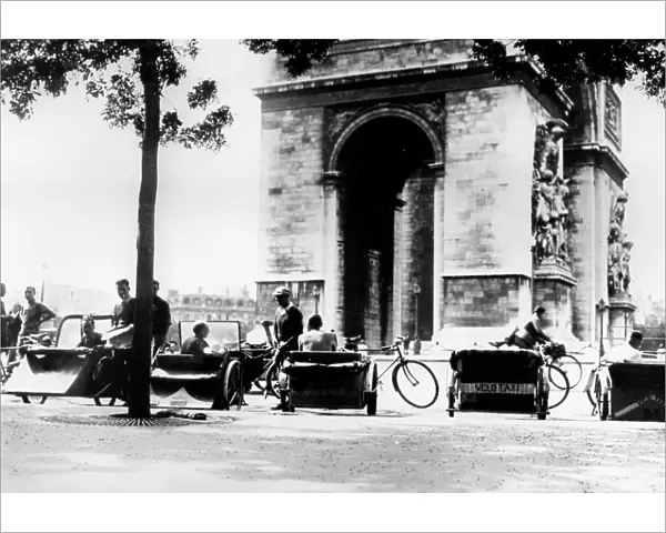 Bicycle taxis in the Place d Etoile by the Arc de Triomphe, German-occupied Paris, August 1943