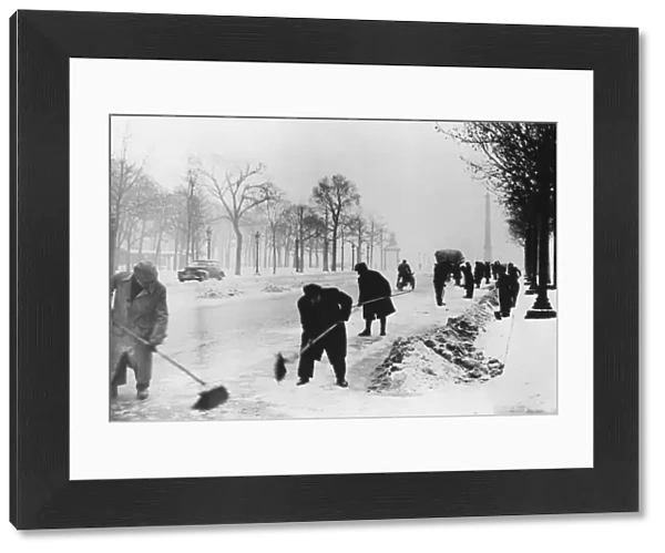 Clearing snow on the Champs Elysees, German-occupied Paris, winter, 1941