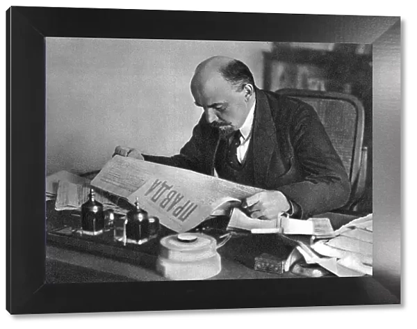 Vladimir Ilyich Ulyanov (Lenin), Russian Bolshevik revolutionary, reading Pravda, 1918