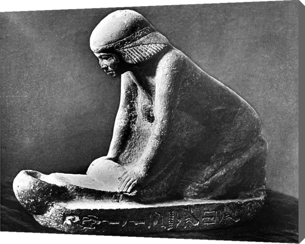 Egyptian tomb figure of a woman grinding corn using a saddle quern, c2500 BC
