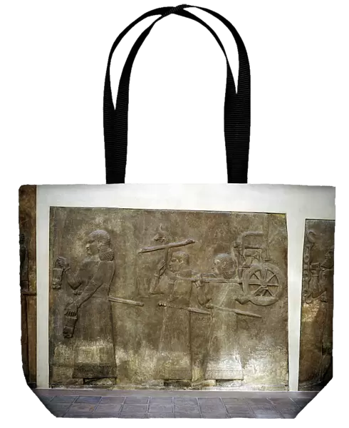 Assyrian relief showing servants carrying the Kings chariot, Khorsabad, c8th century BC