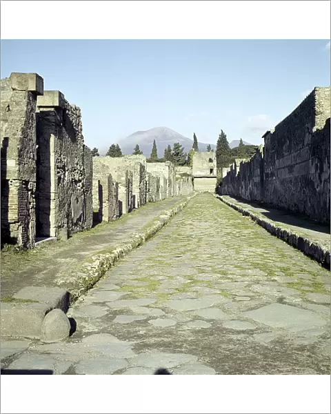 A Pompeii street with Vesuvius in the distance, Italy