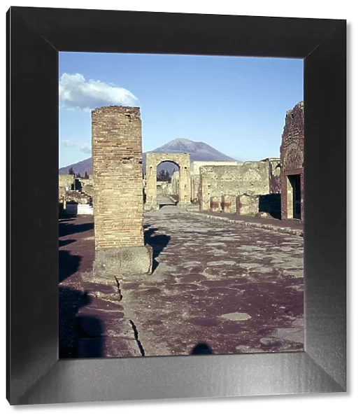 Road leading to Arch of Caligula with Vesuvius beyond, Pompeii, Italy