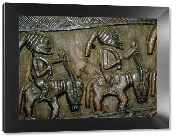 A carved wooden door from Nigeria depicting men on horseback