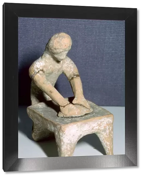 Greek terracotta of a woman making bread