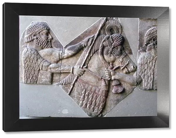 Assyrian relief of a man leading a horse and rider