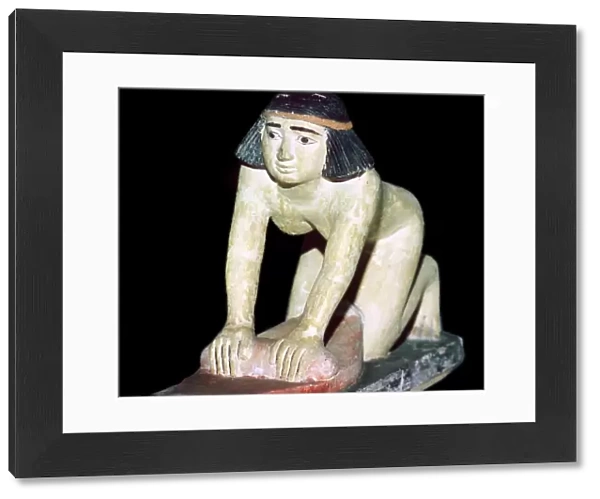Painted figure of an Egyptian servant making bread