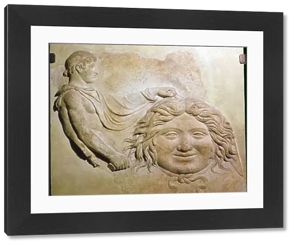 Roman fragment of a terracotta Campana relief showing head of Medusa with figure of Perseus