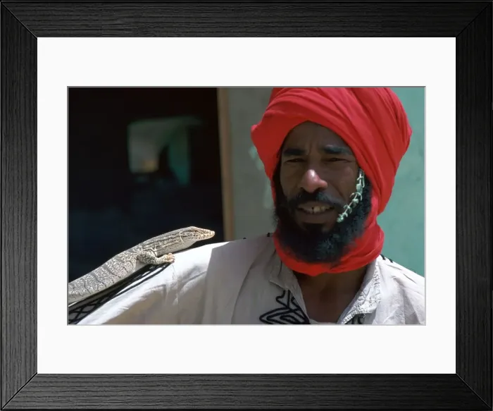 Framed Print : Keeper with a lizard in Tozeur zoo in Tunisia Framed Print : Keeper with a lizard in Tozeur zoo in Tunisia