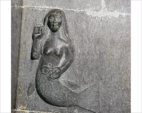 Mermaid on the chancel arch of Clonfert Cathedral, 12th century